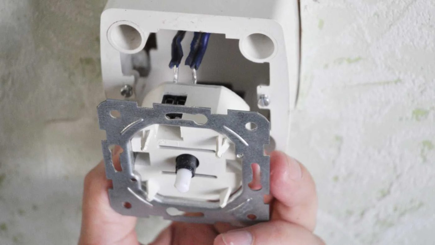 Light switch dimmer. Electrician installing and repair a dimmer switch in a wall socket.