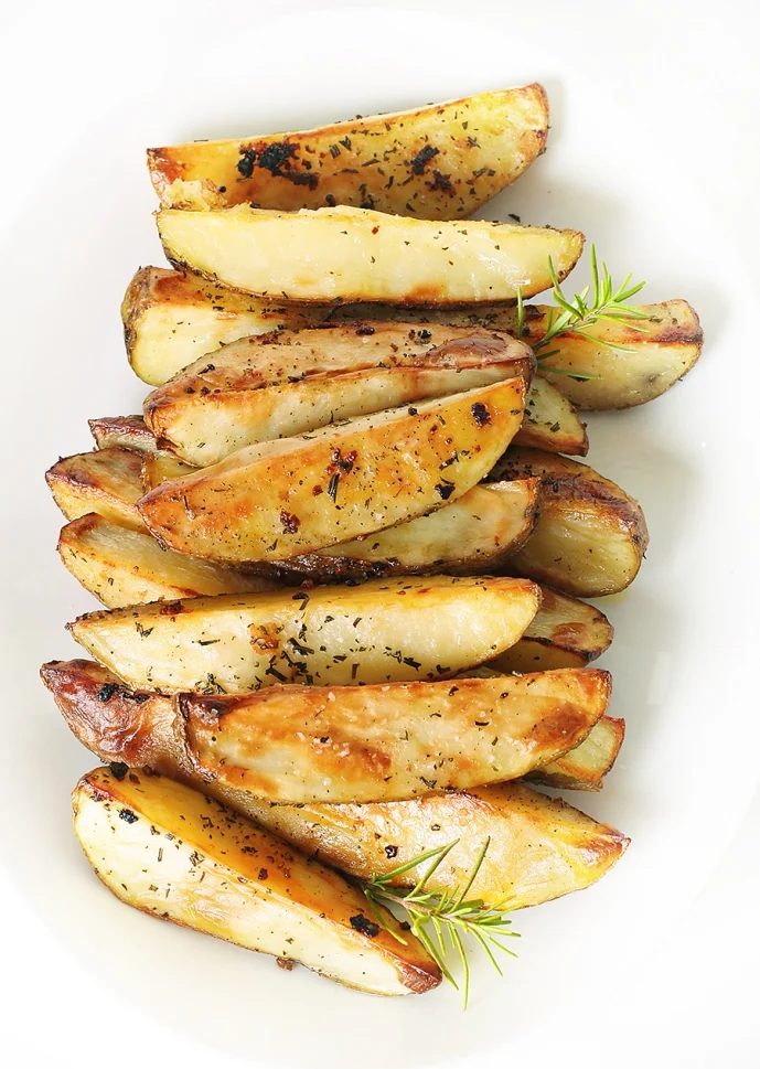 Banish boring potato sides and give your next party a punch by making one of these flavorful potato wedge recipes. 10 Flavorful Potato Wedge Recipes ~ Tipsaholic.com #sides #potato