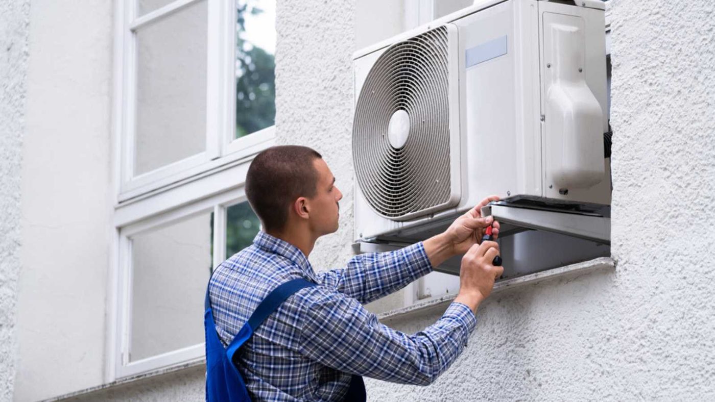 Man Doing Repair In AC Unit