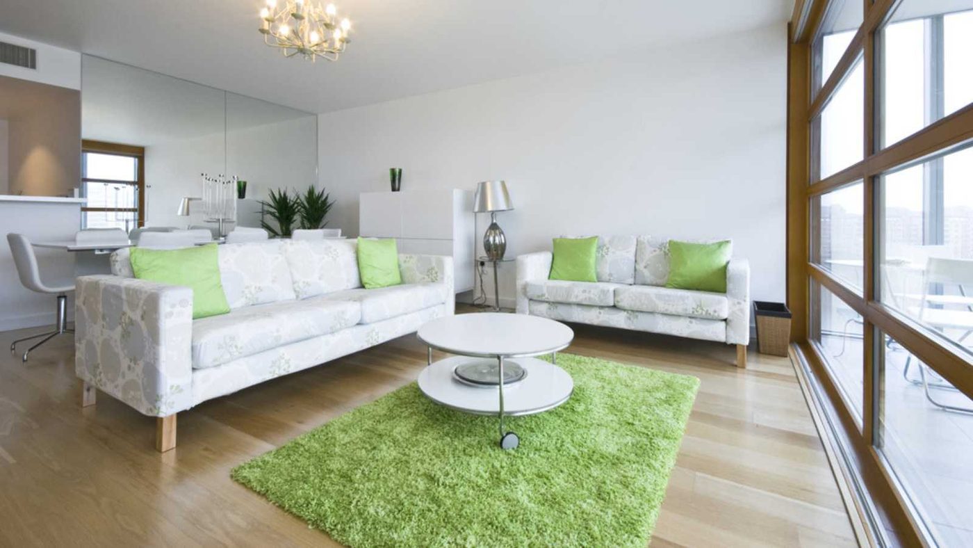 Contemporary living area with designer furniture and carpet