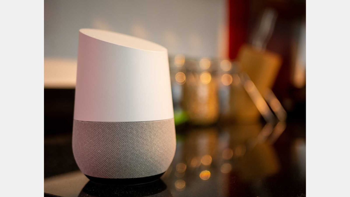 Smart home assistant speaker on kitchen worktop in home setting