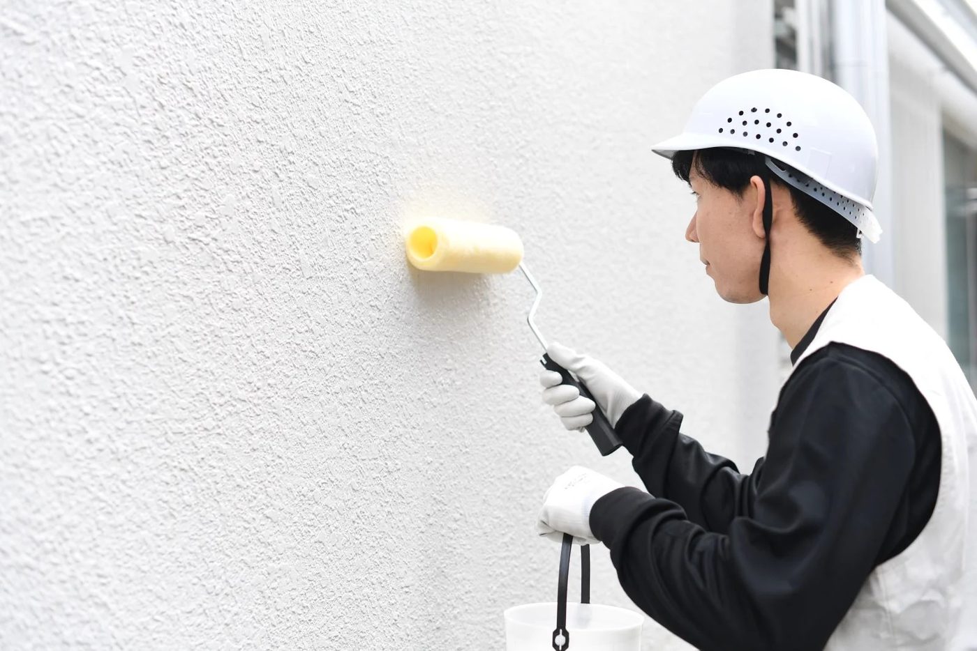 Man Painting Using Paint Roller