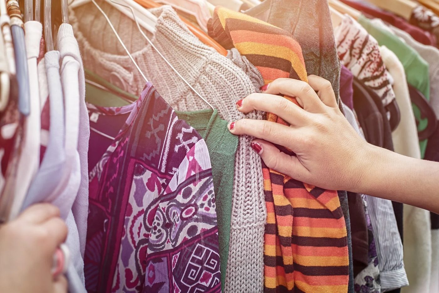 14 Tips For Scoring The Best Thrifting Deals Finding Items On A Clothes Rack Shutterstock