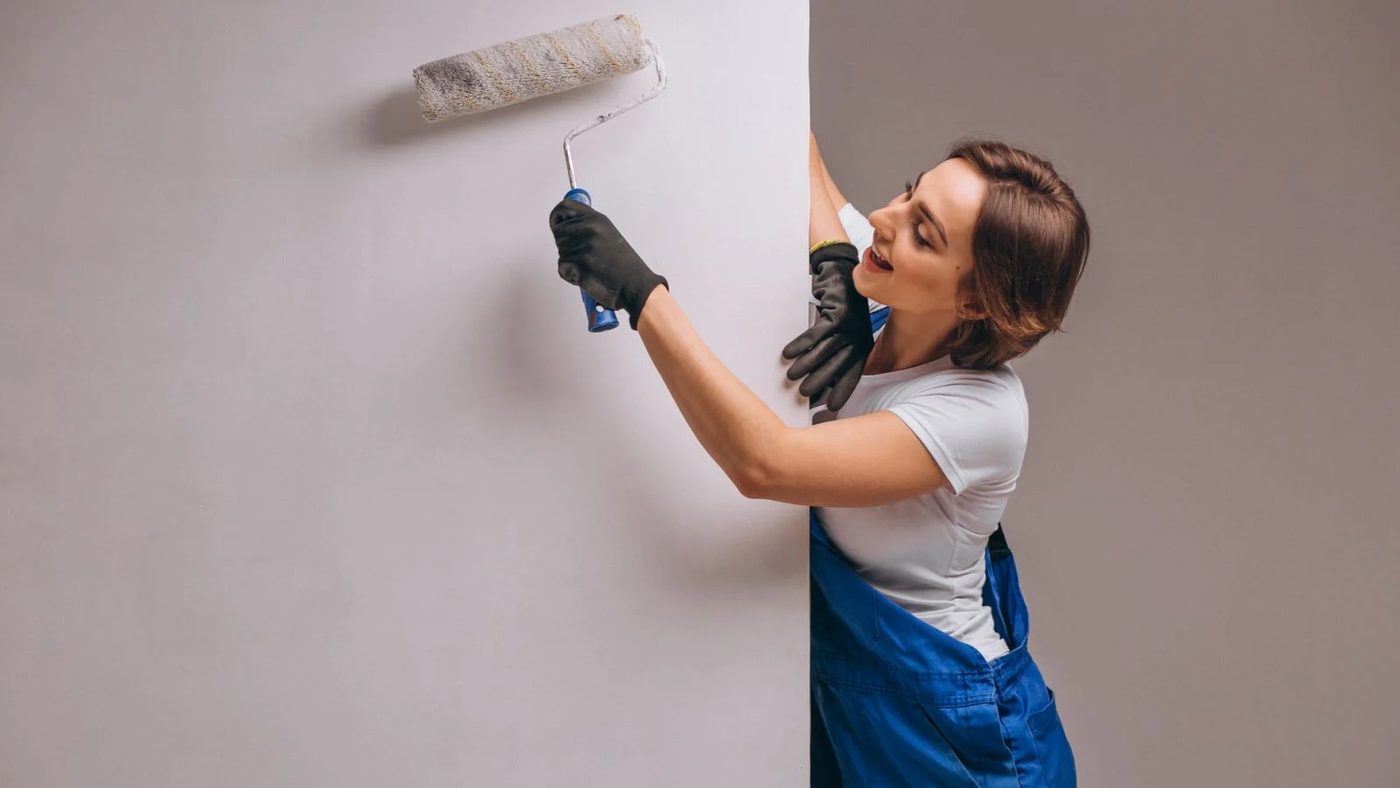 Girl Painting Wall Using Roller
