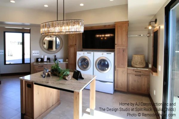 Large Laundry Room With Wood Cabinets and TV