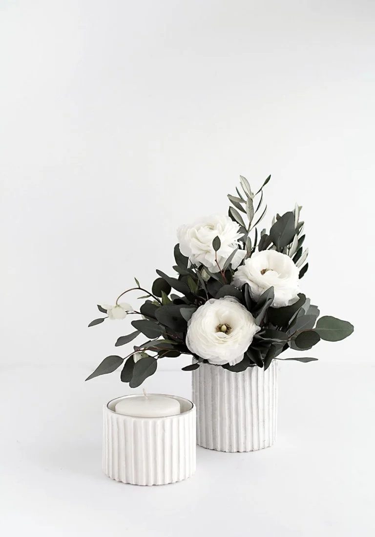 Textured White Vertical Line Vases, One With White Candle, Another With Greenery And Flowers