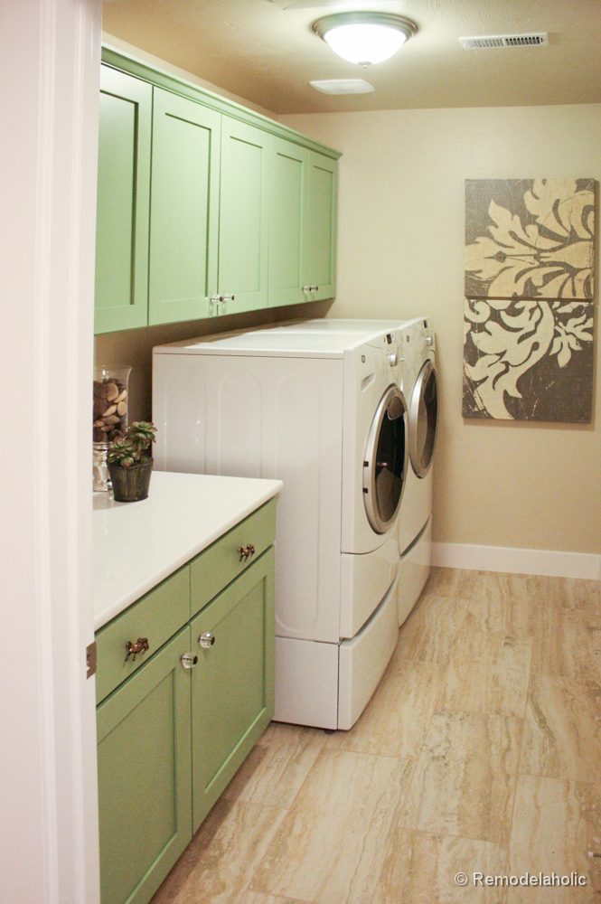 Pretty Green Cabinets in a one wall laundry room. Fabulous Laundry room design options from @Bekob