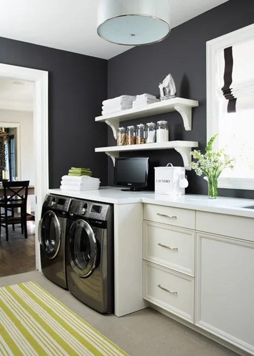 Laundry room in kitchen or mudroom space, black walls and looks striking featured on Bekob.com