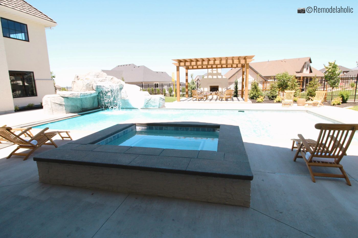 Pergola by memorable pool with waterfall and hot tub, UVPH 2018 Home 4 Raykon Construction, Erin Hansen Design, Photo by Bekob