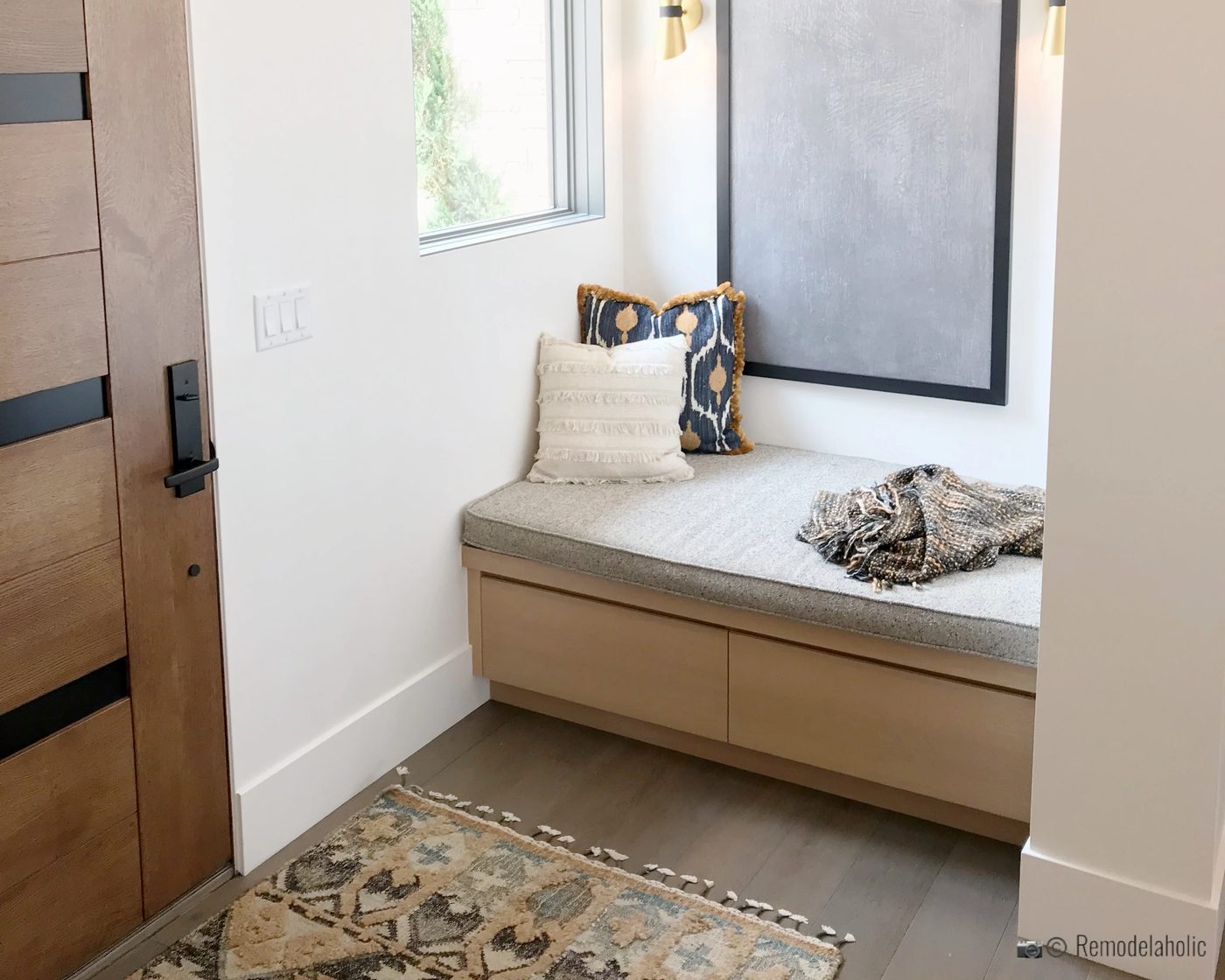 Add a storage bench in the entryway for extra seating and hidden storage, SLPH 2018 Home 14 Magleby Communities, photo by Bekob
