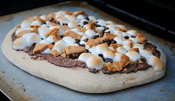 S'mores and pizza are two of my favorites, this sounds like a match made in heaven. S'mores Dessert Pizza by You Made That.
