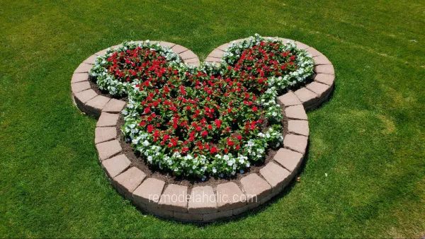 handmade-mickey-planter-bed-with-landscaping-blocks-and-red-and-white-flowers-Bekob