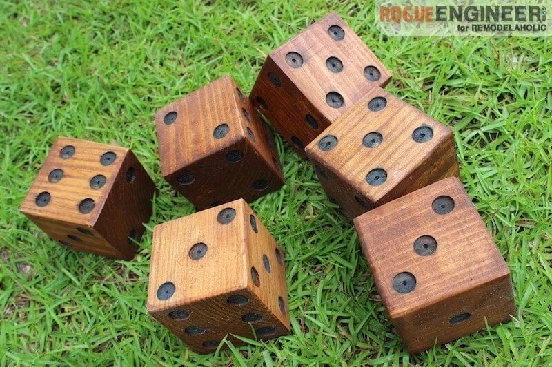 Handmade Yard Dice Made Of Wood, Stained, Rolled On Grass