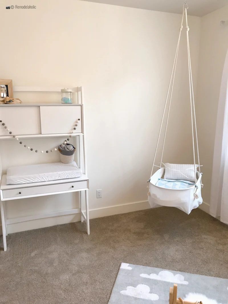 Baby boy nursery with a cute swinging chair hanging from the ceiling. SLPH 2018 Home 5 Regal Homes, photo by Bekob
