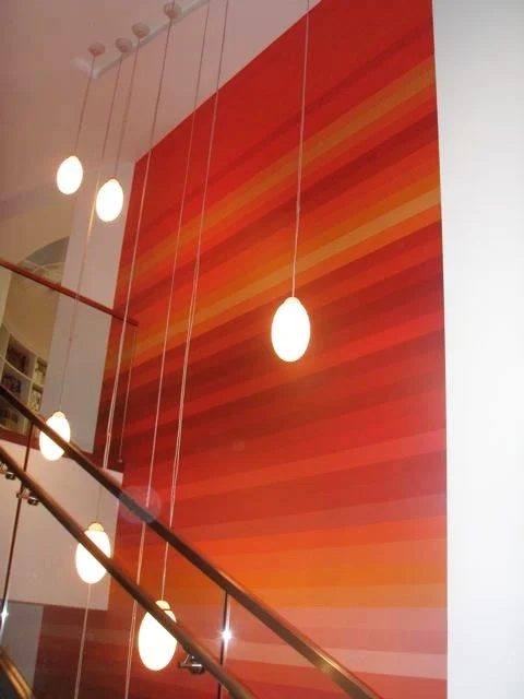multi color stripes ombre red and orange wall on a tall stair wall, creative straightforward wall painting designs