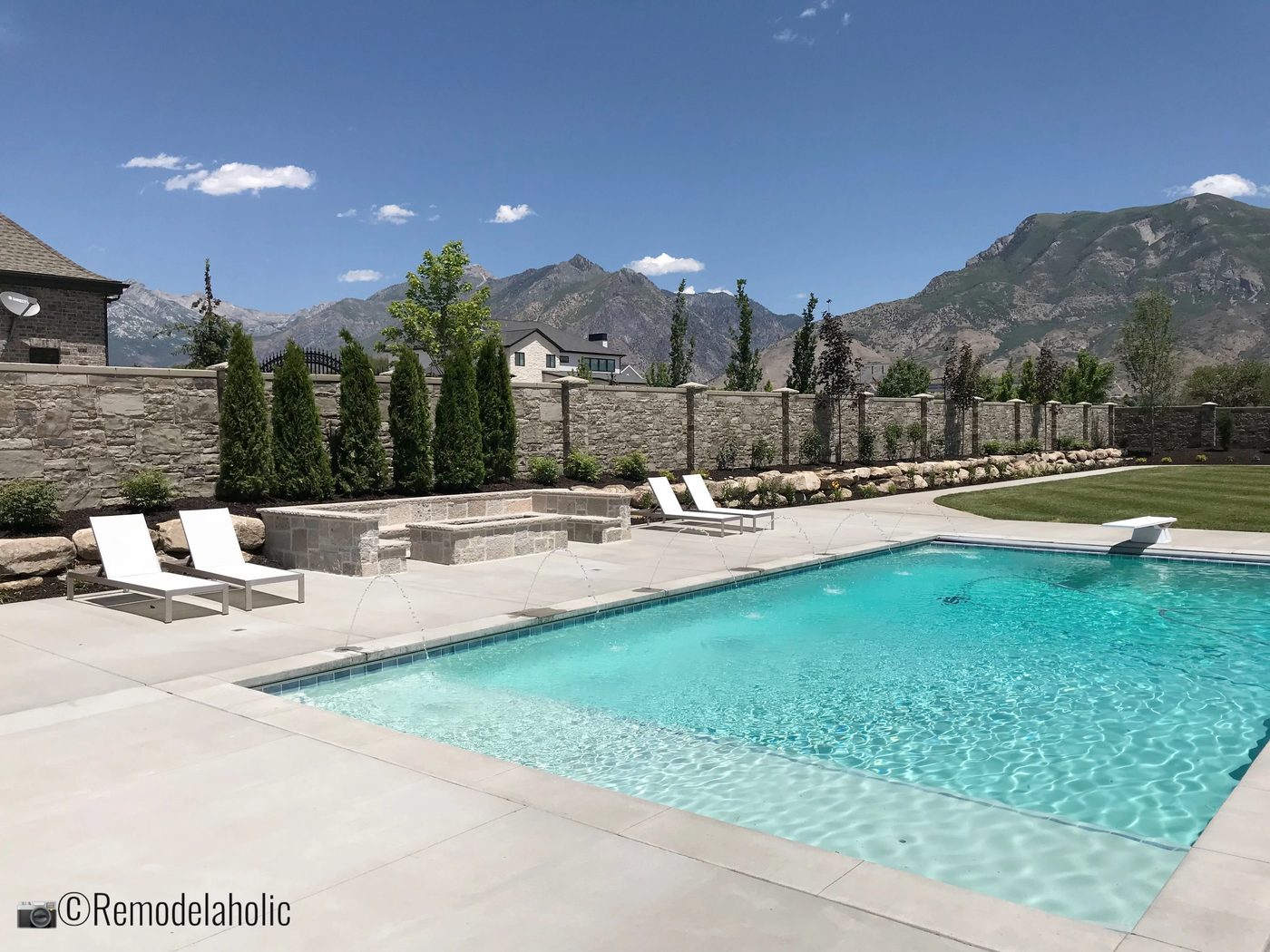Add balance by placing two chaise lounges on each side of a fire pit near a pool. UVPH 2018 Home 17 Millhaven Homes, Four Chairs Furniture & Design, Photo by Bekob