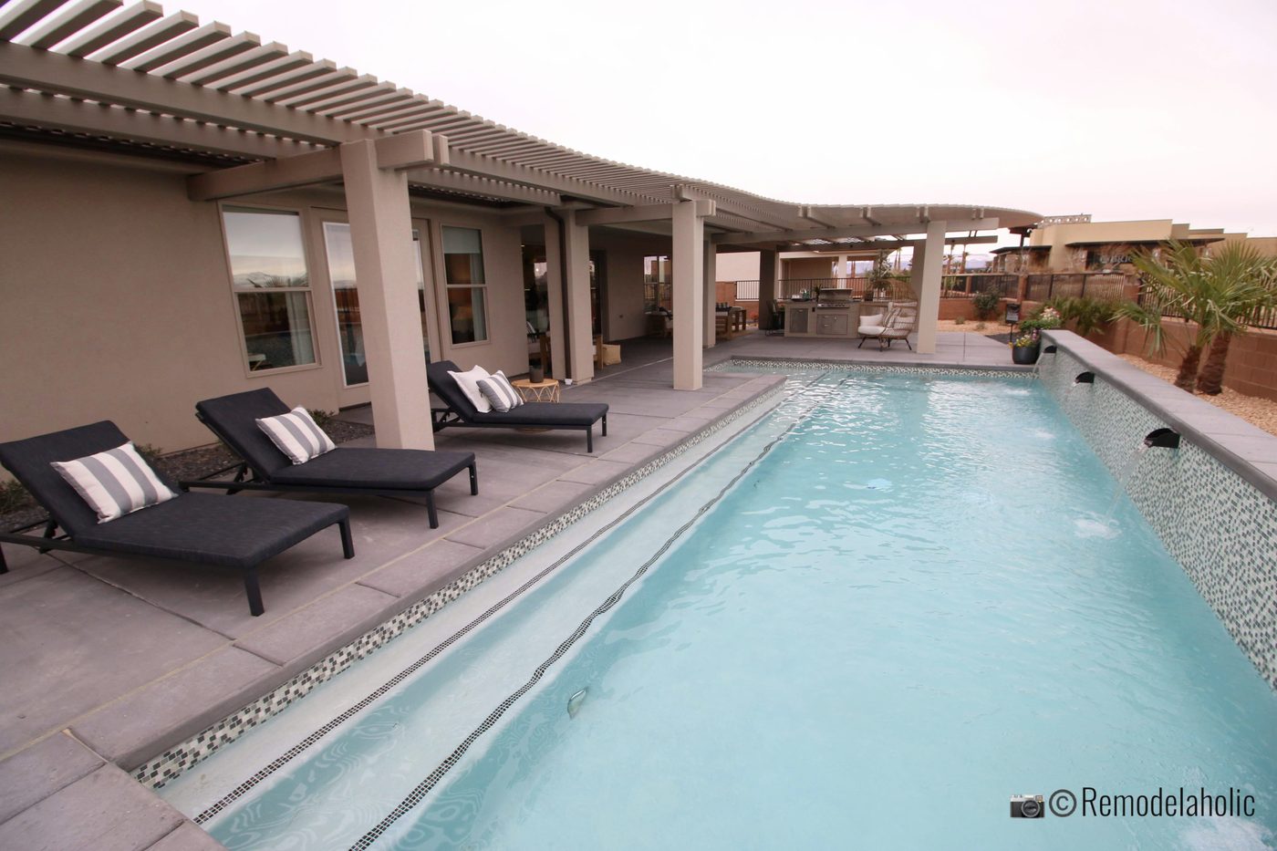 Add cute pillows to lounge chairs for a fun look by the pool, SGPH 2019 House 07 Brio Homes LLC, Photo by Bekob