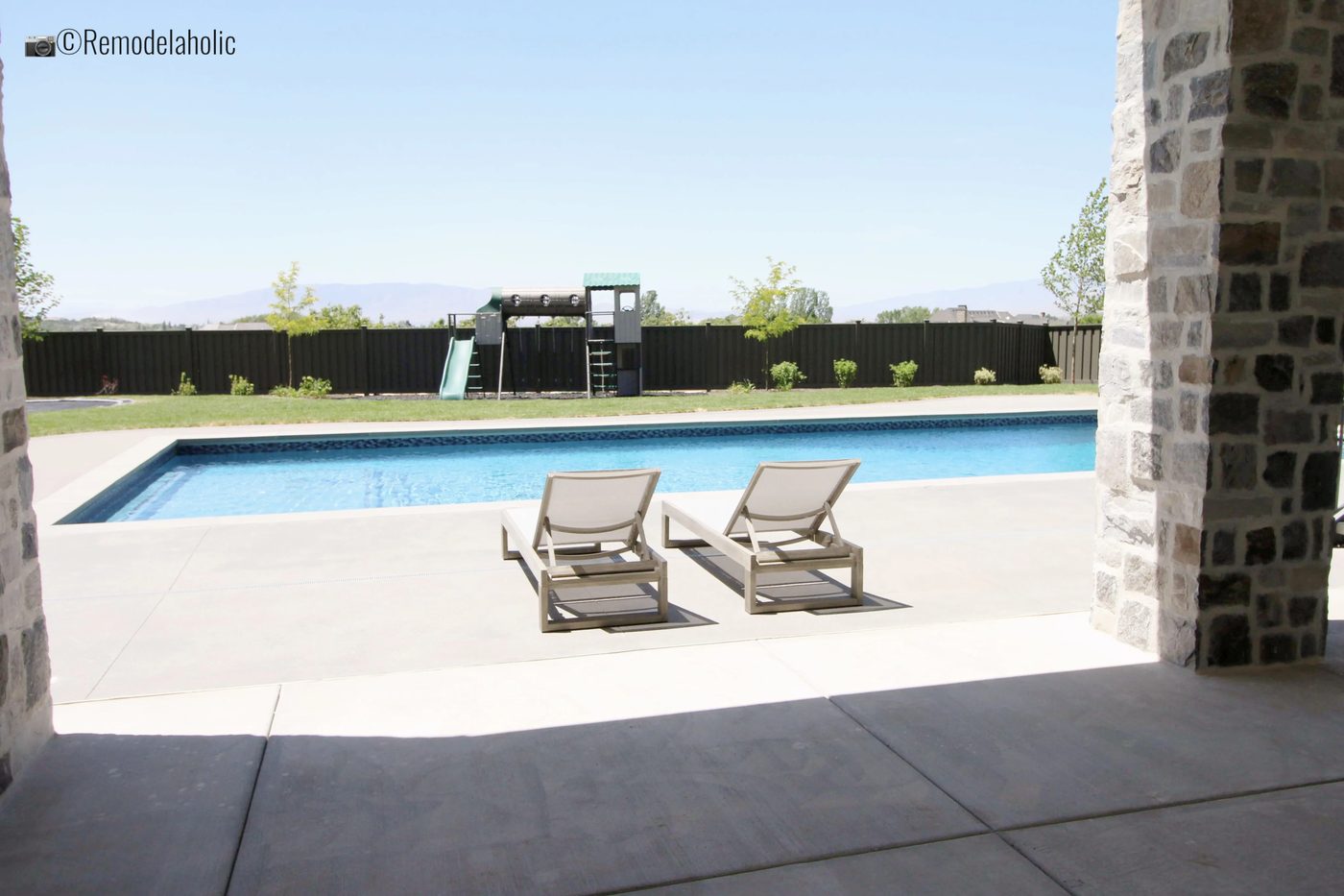White chaise lounge chairs by the pool, UVPH 2018 Home 33 E Builders, Erin Hansen Design, Photo by Bekob