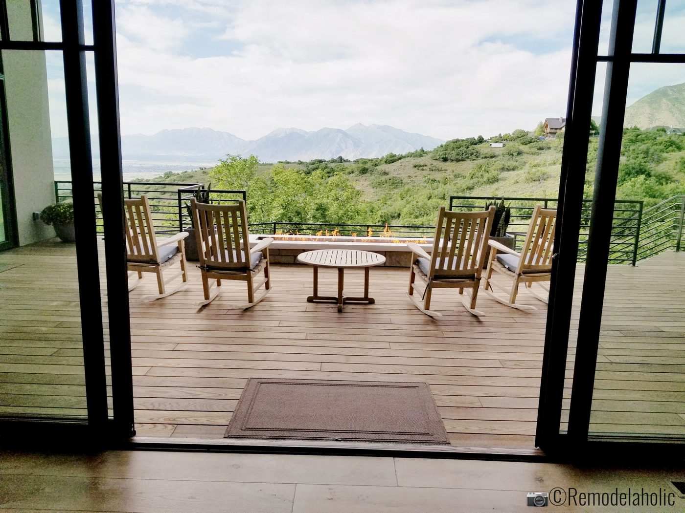 Rocking chairs, a view, and a long rectangle fire table, UVPH 2018 Home 2 Split Rock Fine Homes, Photo by Bekob