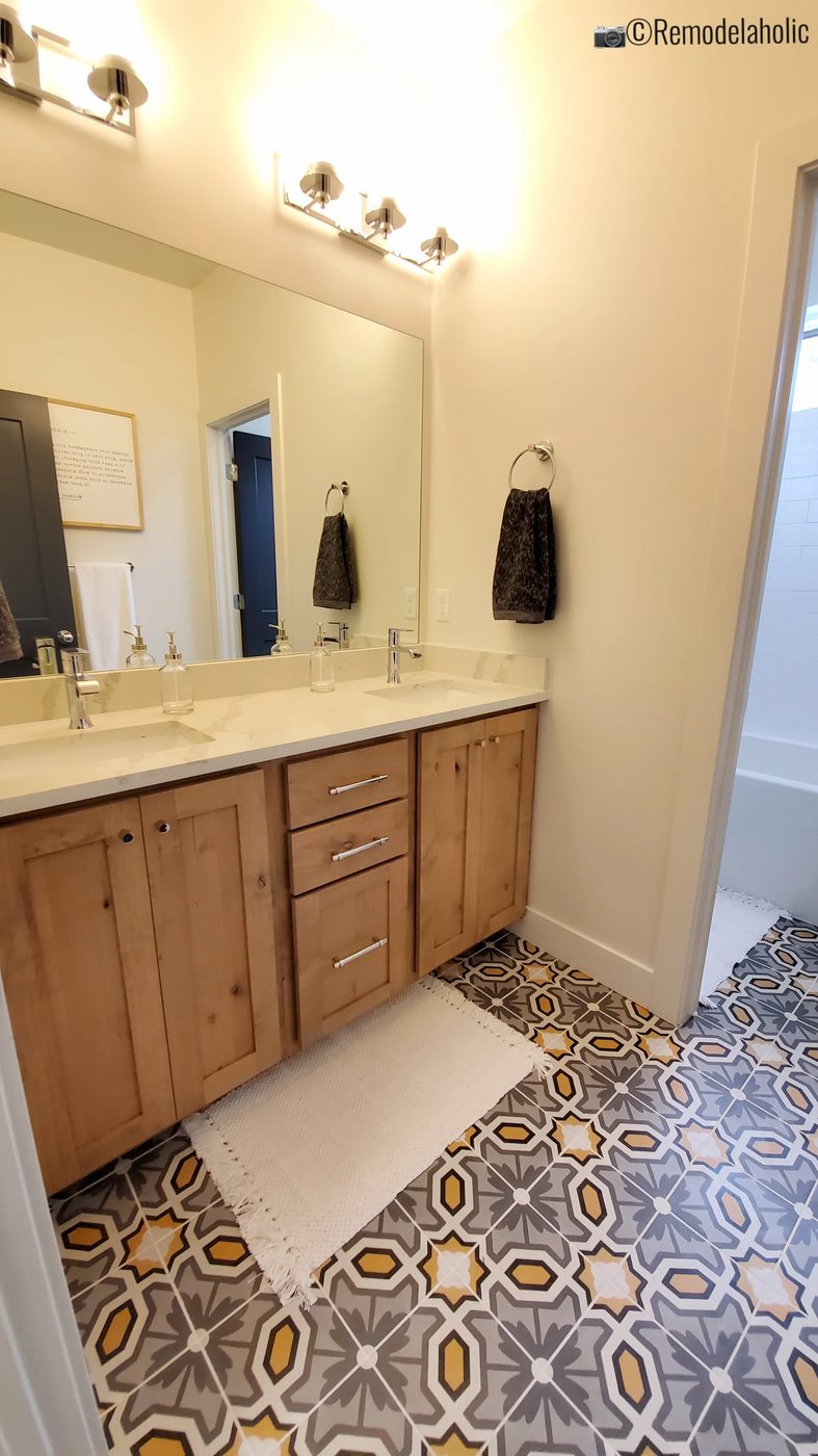 Classy floor tile in a master bathroom with double sinks. UVPH 2021 Home 05 Journey's End Homes Designer Briks Home And Design, Photo by Bekob