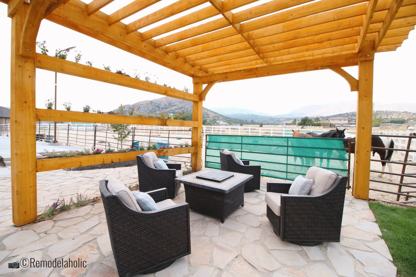 Seating area beneath a pergola near horses with planter boxes, SLPH 2018 Home 17 Green Haven Homes, Photo by Bekob