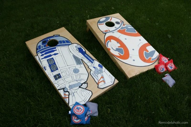 custom painted cornhole boards painted with Star Wars droids BB-8 and R2-D2, on the grass in a backyard