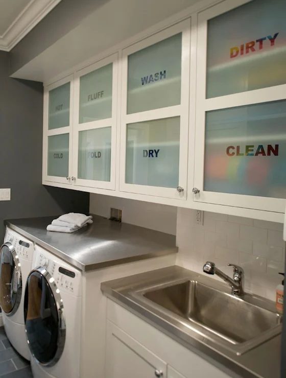 modern cabinet frosted glass storage area above washer and dryer in the laundry room featured on Bekob.com