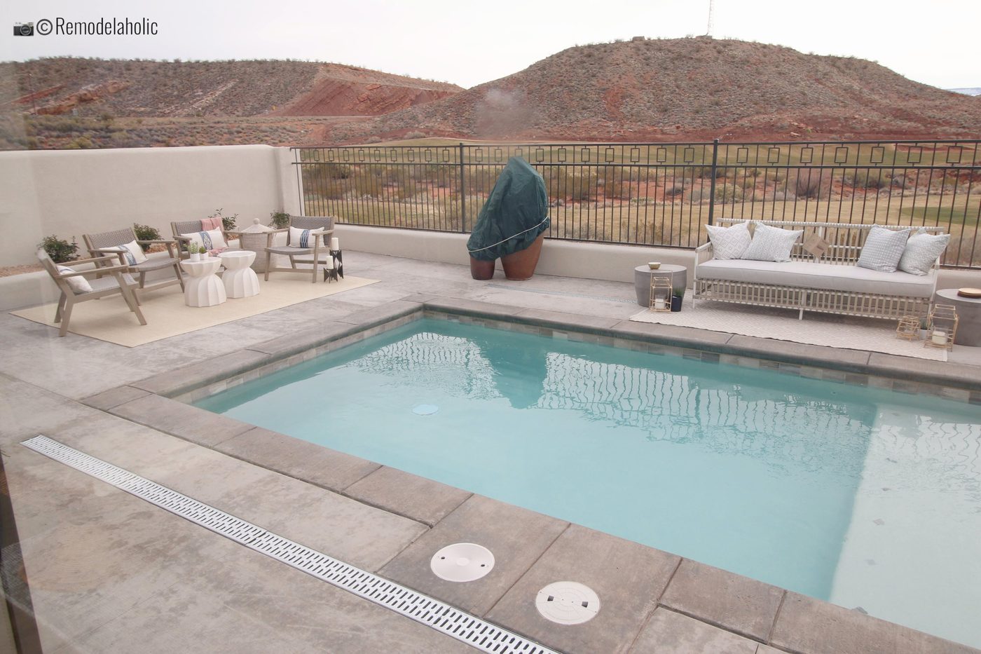 Wicker Sofa with Pillows by the Pool. SGPH 2019 House 03 Cole West Resorts LLC, Photo by Bekob