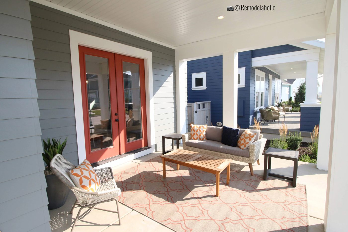 striking outdoor patio space with area rug and sofa. SLPH 2018 Home 19 David Weekley Homes, Photo by Bekob