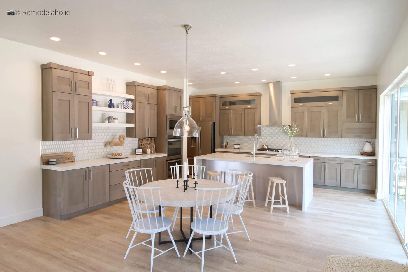 vivid white spindle chairs in a neutral wood tone kitchen, SLPH 2018 Home 5 Regal Homes, photo by Bekob
