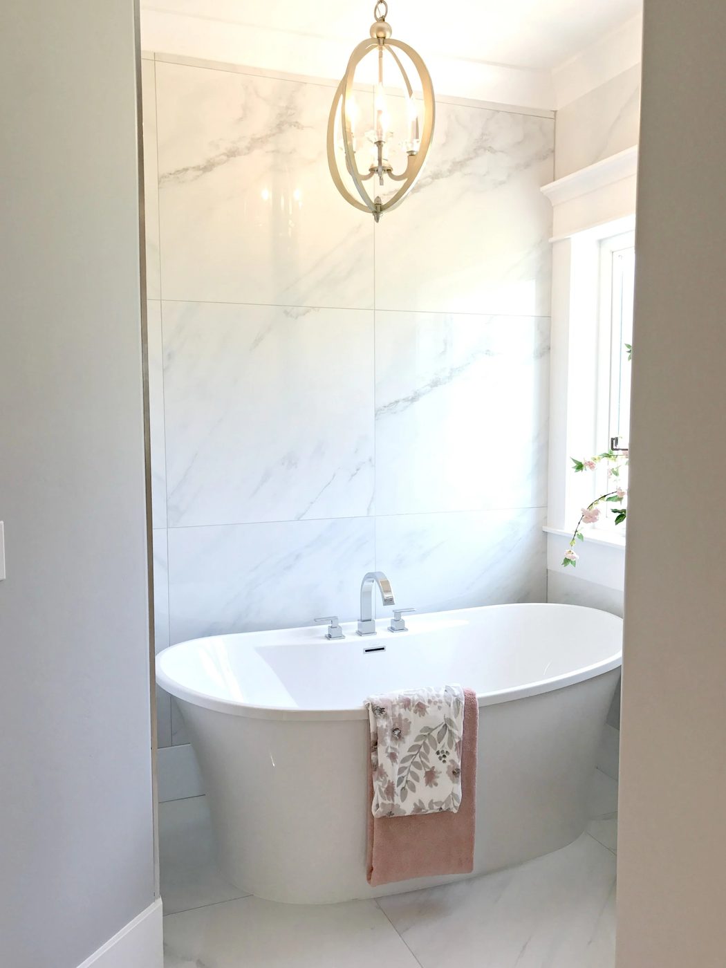 striking master bath with chandelier. UVPH17 House 6 E&L Custom Homes, Photo by Bekob.com
