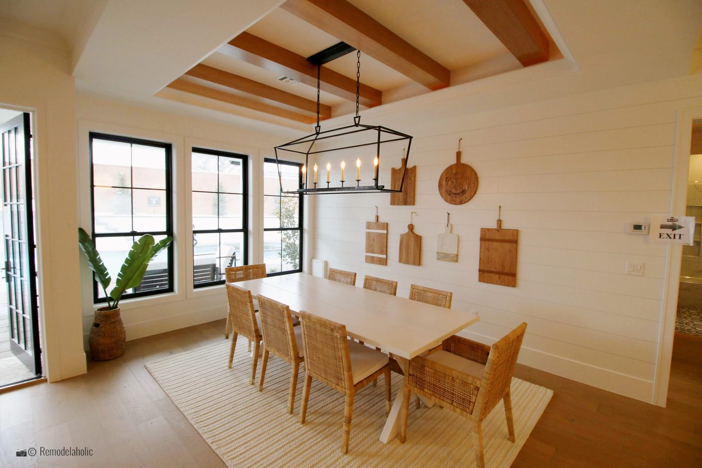 striking neutral wicker style dining chairs in neutral dining room space, SGPH 2019 House 24 K Welch Homes, Photo by Bekob
