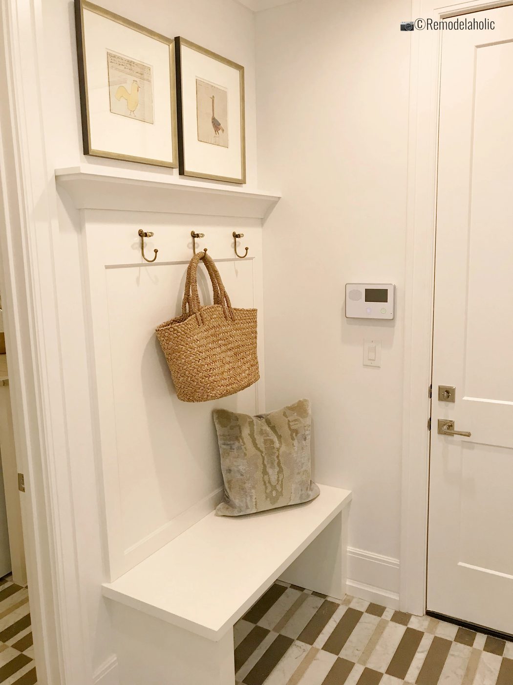 direct white build in mudroom bench with hooks. SLPH 2018 Home 4 Ivory Homes, Photo by Bekob.com