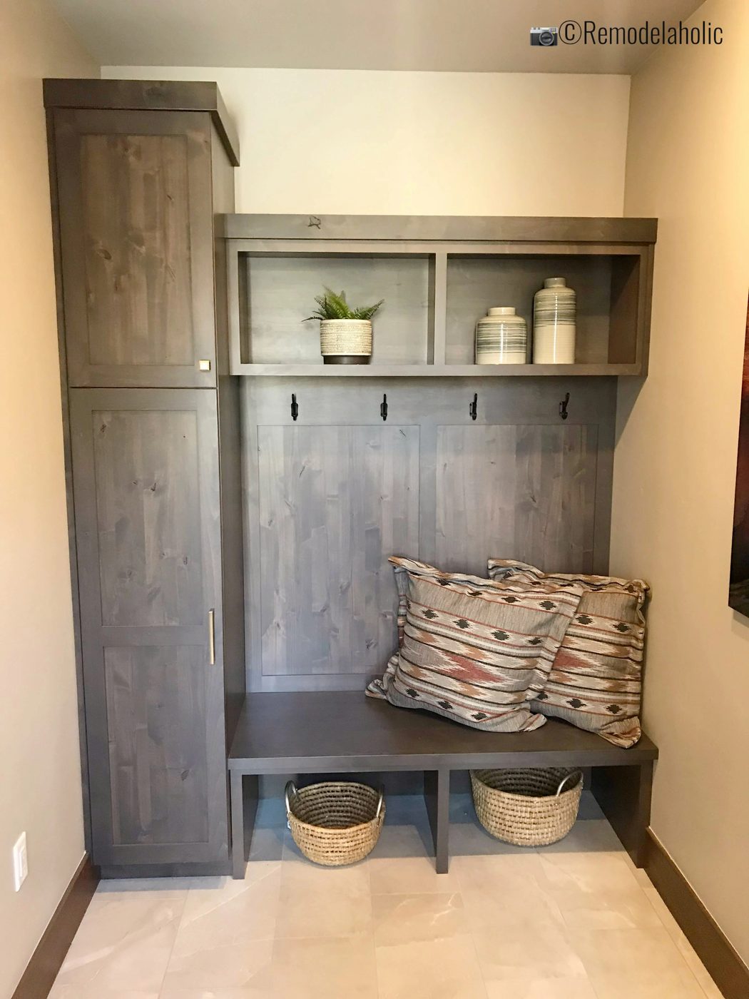 Decorate with patterned pillows for different styles and seasonal looks in the mudroom. SGPH 2019 House 21 AJ Construction, Photo by Bekob