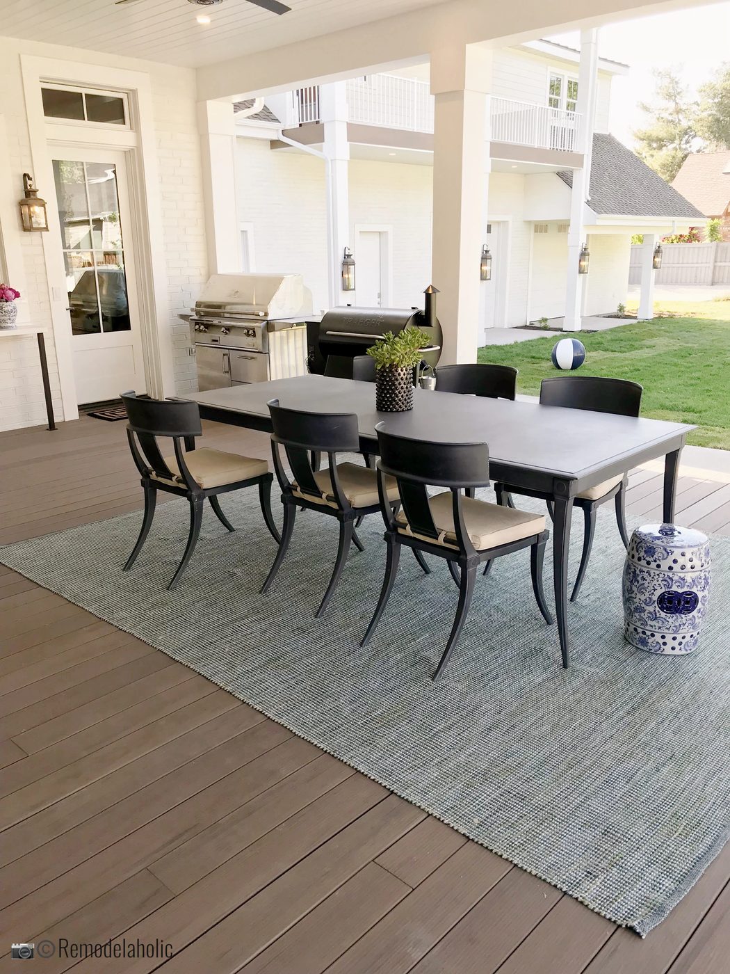 Use an area rug to anchor an outdoor dining space. UVPH 2018 Home 13 Robison Home Builders, Alice Lane Interior Design (405)
