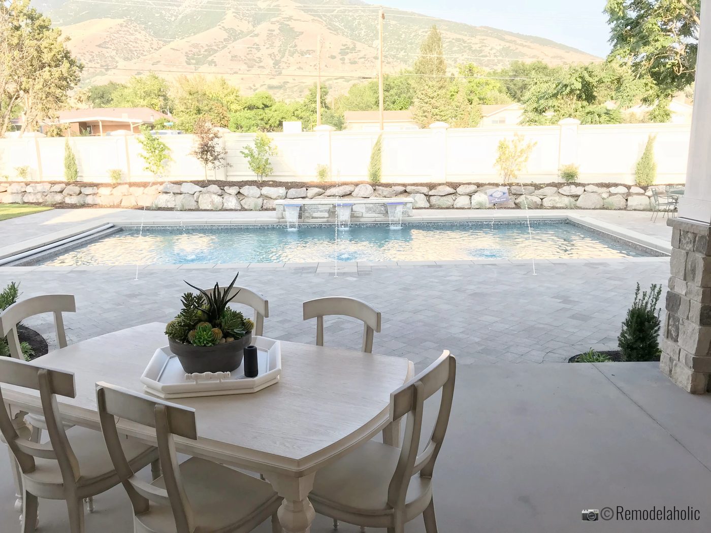 Pretty farmhouse table by the pool. SLPH 2018 Home 6 Bradshaw Homes & Property, Photo by Bekob