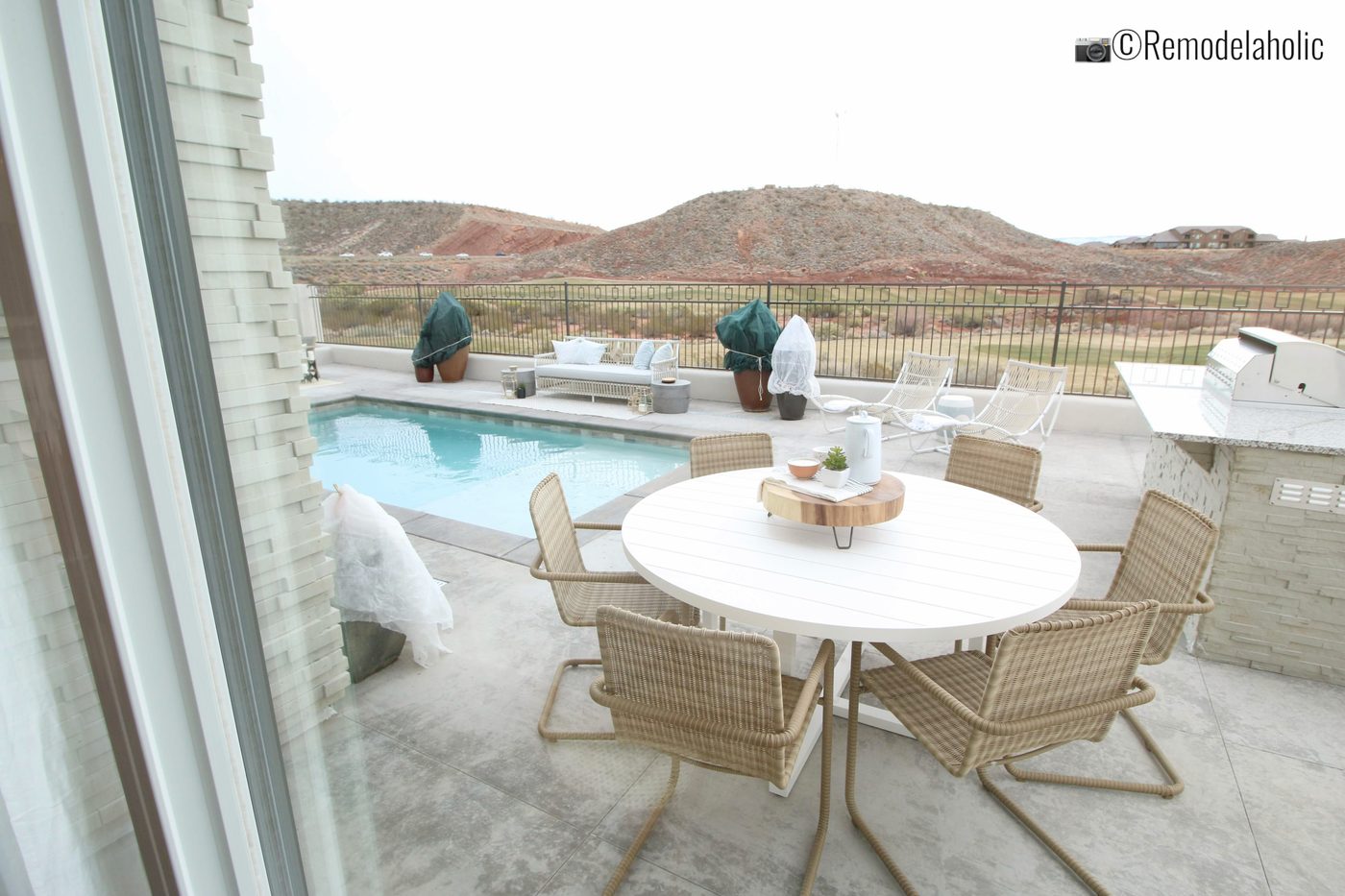 Pretty white and tan patio set. SGPH 2019 House 03 Cole West Resorts LLC, Photo by Bekob