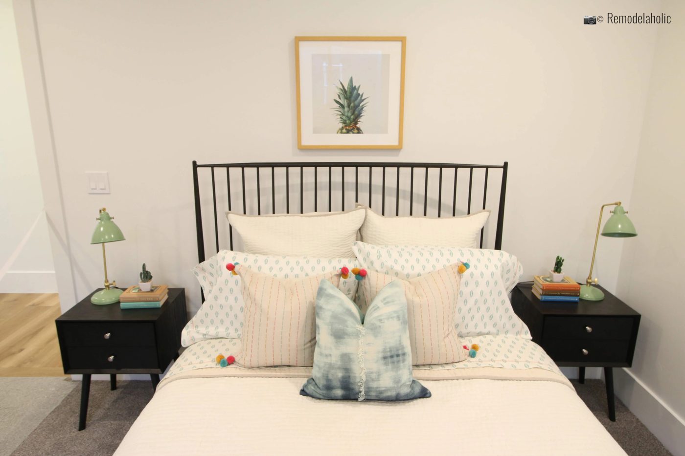 Black spindle style headboard, styled with cut pillows. UVPH 2018 Home 17 Millhaven Homes, Four Chairs Furniture & Design, Photo by Bekob