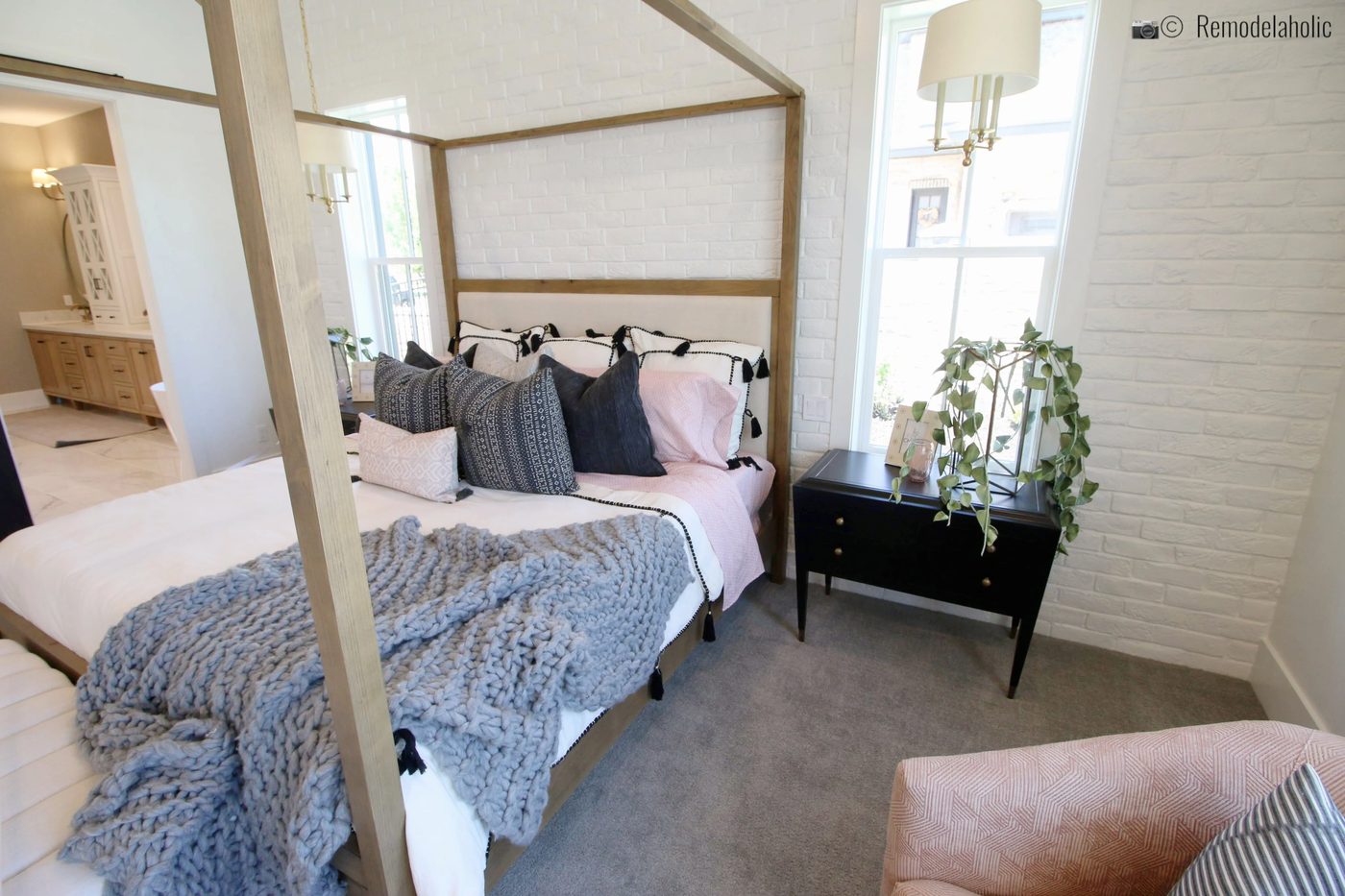 Pretty natural wood four poster upholstered bed in a pretty master bedroom, UVPH 2018 Home 17 Millhaven Homes, Four Chairs Furniture & Design, Photo by Bekob