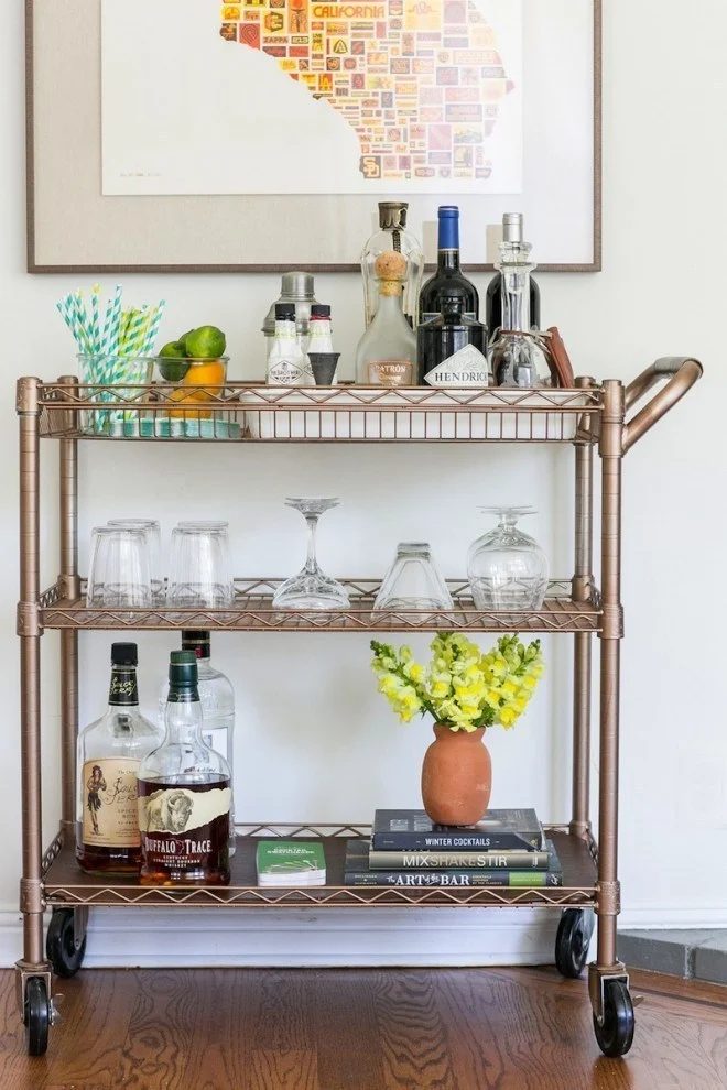 Metal Bar Cart With Drinks, Glasses, Books, Straws, Fruit And Flowers In Vase