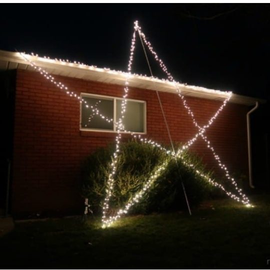 Red Brick House With Giant Star Made Out Of Christmas Lights