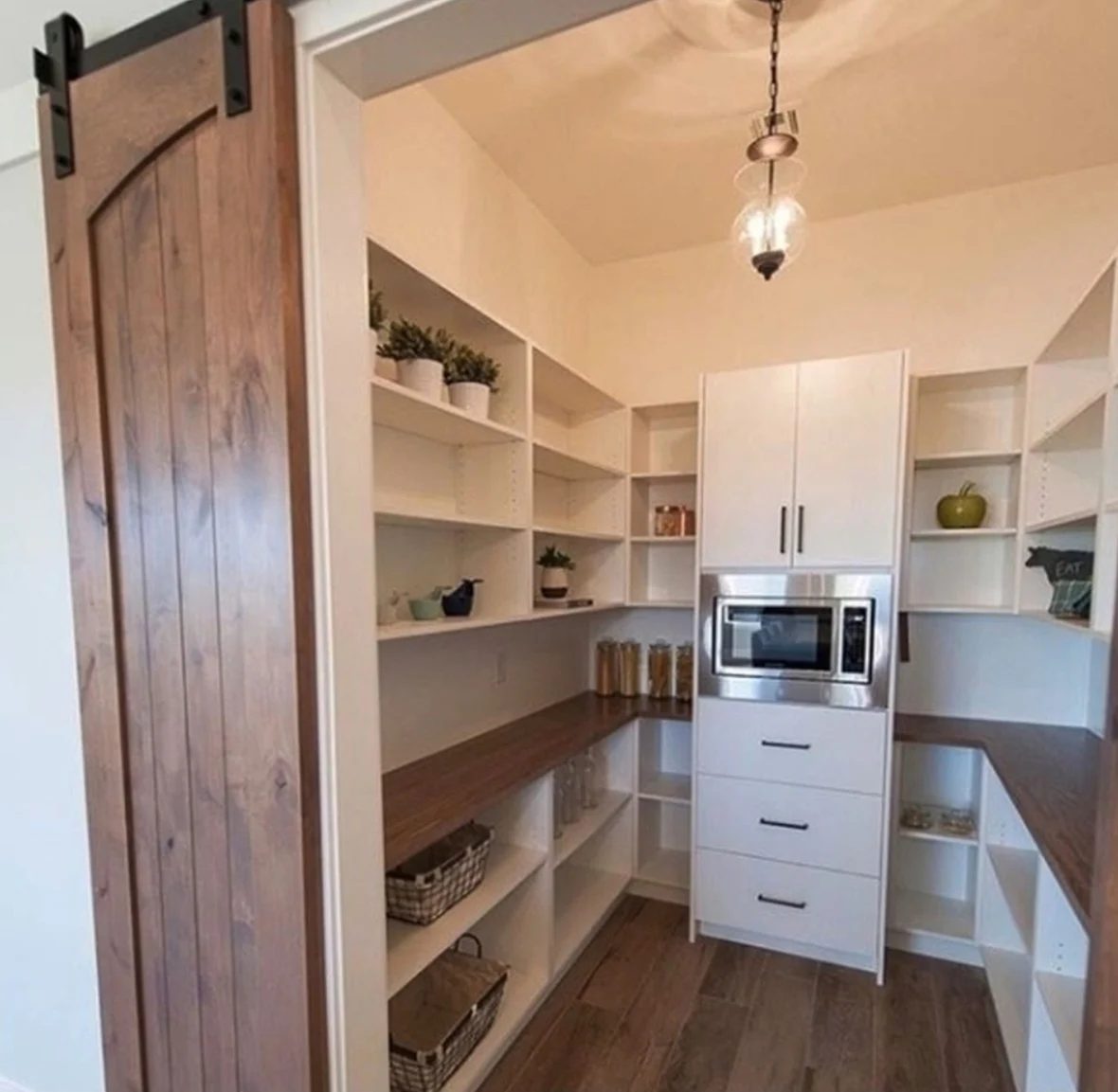 strong White Pantry With Shelves On Every Wall And Wooden Barn Door