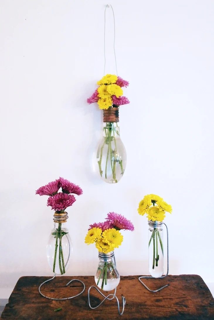 Glass And Metal Flower Vases With Bright Pink And Yellow Flowers