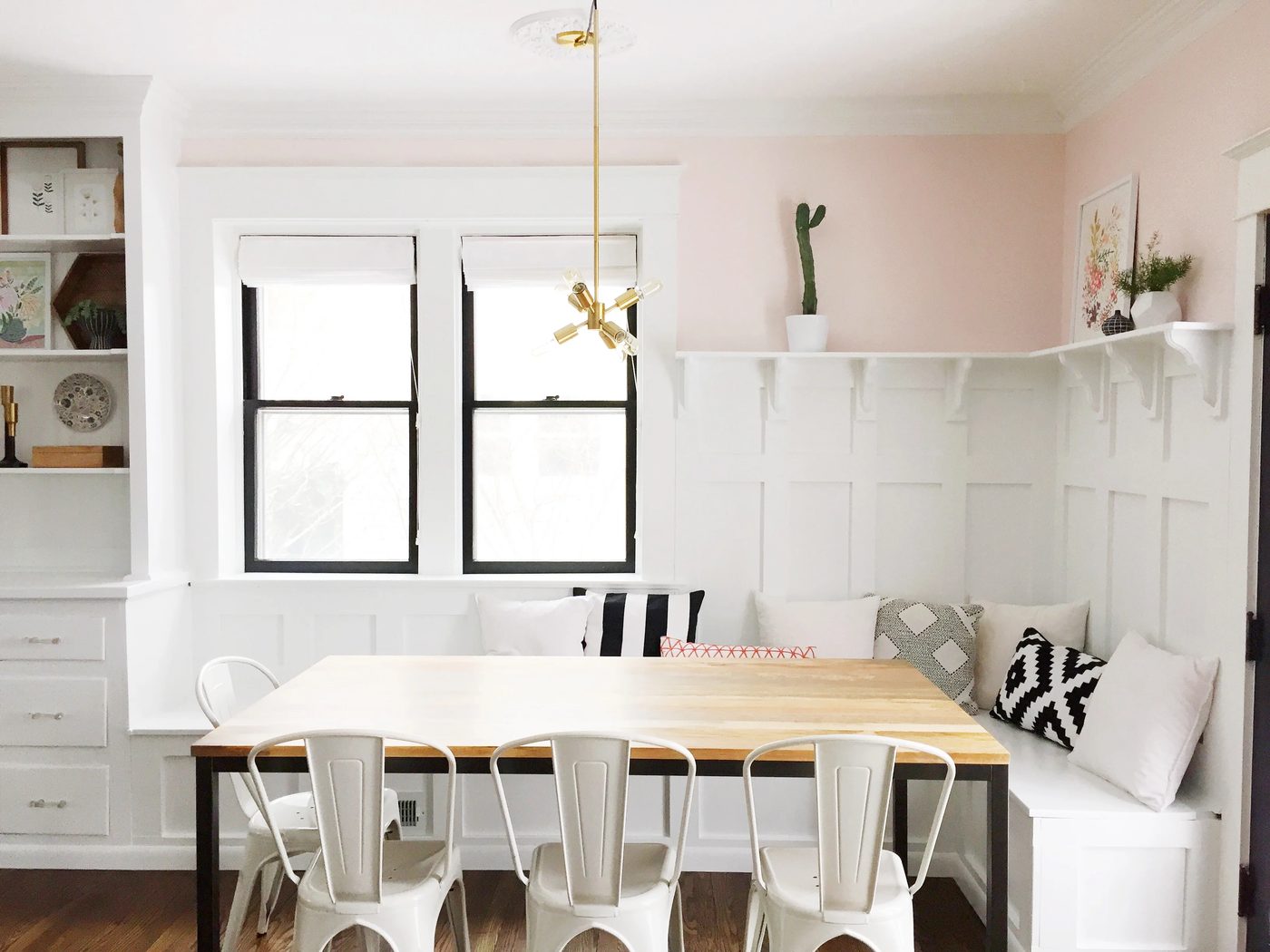 vivid dining room banquette plus built-in hutch. The paneled board and batten below the ledge is vivid above the banquette!
