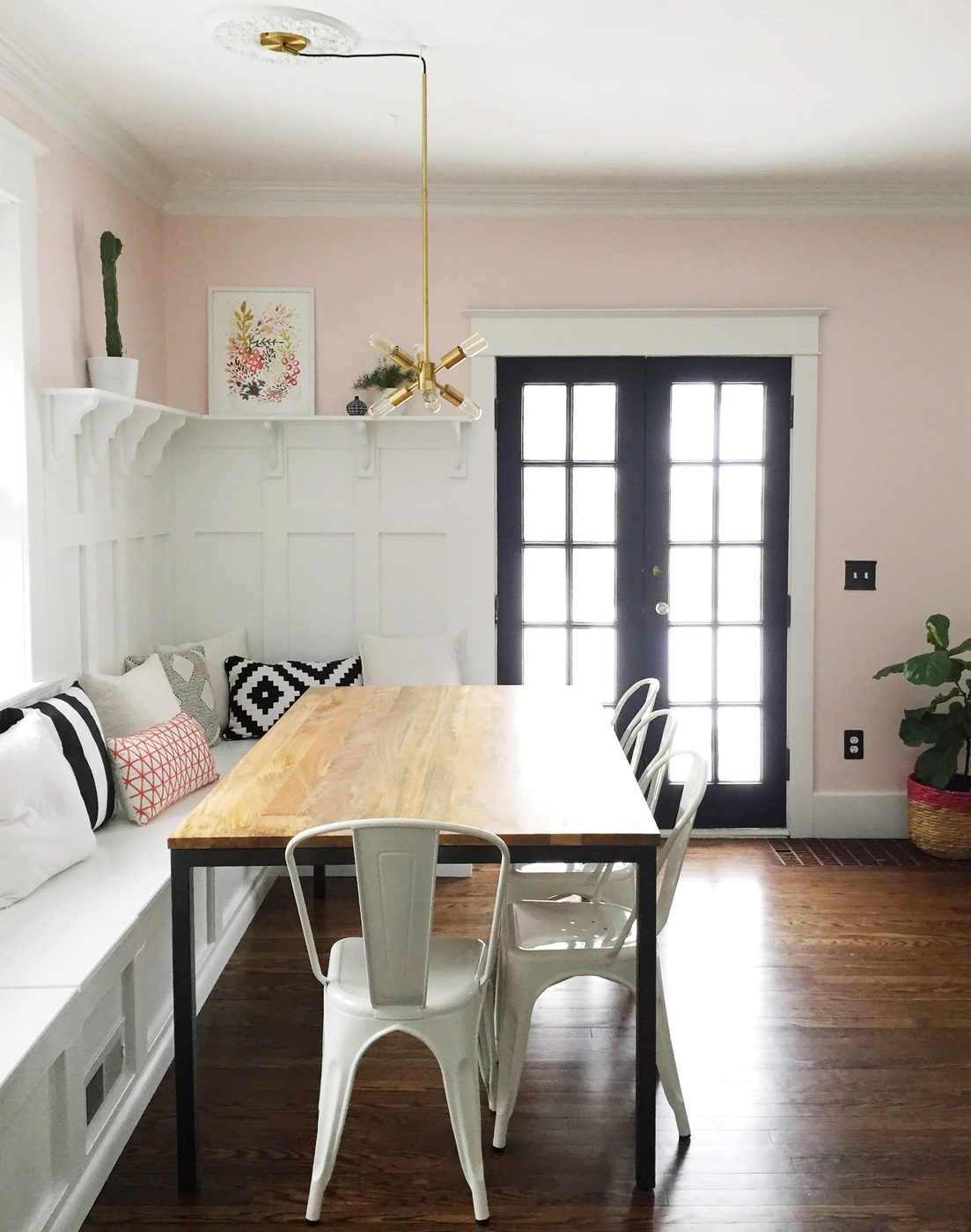 vivid dining room banquette plus built-in hutch. The paneled board and batten below the ledge is vivid above the banquette!