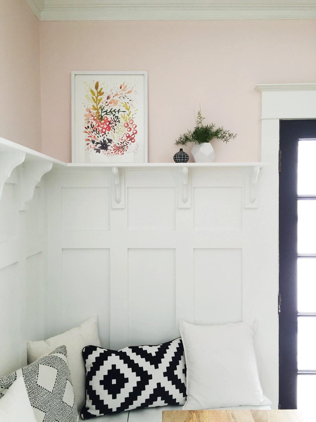 This board and batten wainscoting wall treatment above this dining room banquette is well fitted!