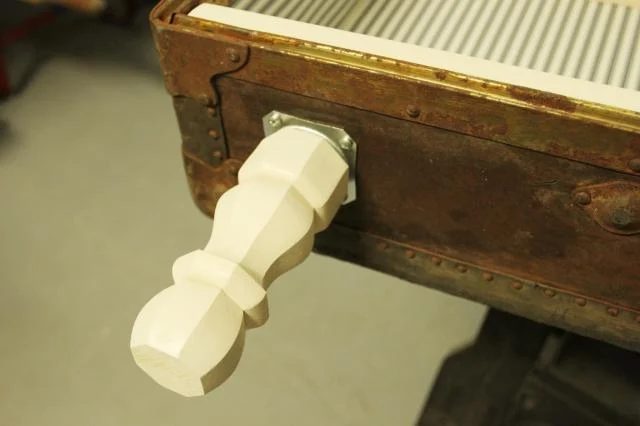 add leg brackets for antique suitcase bookshelf makeover, featured on Bekob.com
