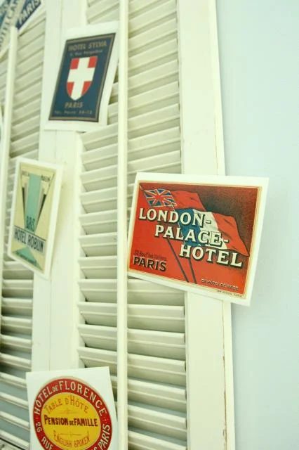 travel postcard shutter display above antique trunk bookshelf, featured on Bekob.com
