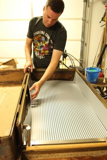 add liners to inside of old trunk to make bookshelf, featured on Bekob.com