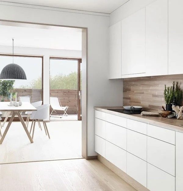 White Kitchen with Wood Looking Backsplash Apartment 34